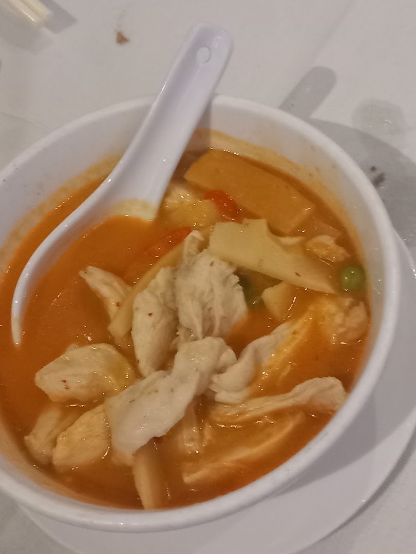 Bowl of chicken curry with bamboo shoots and vegetables